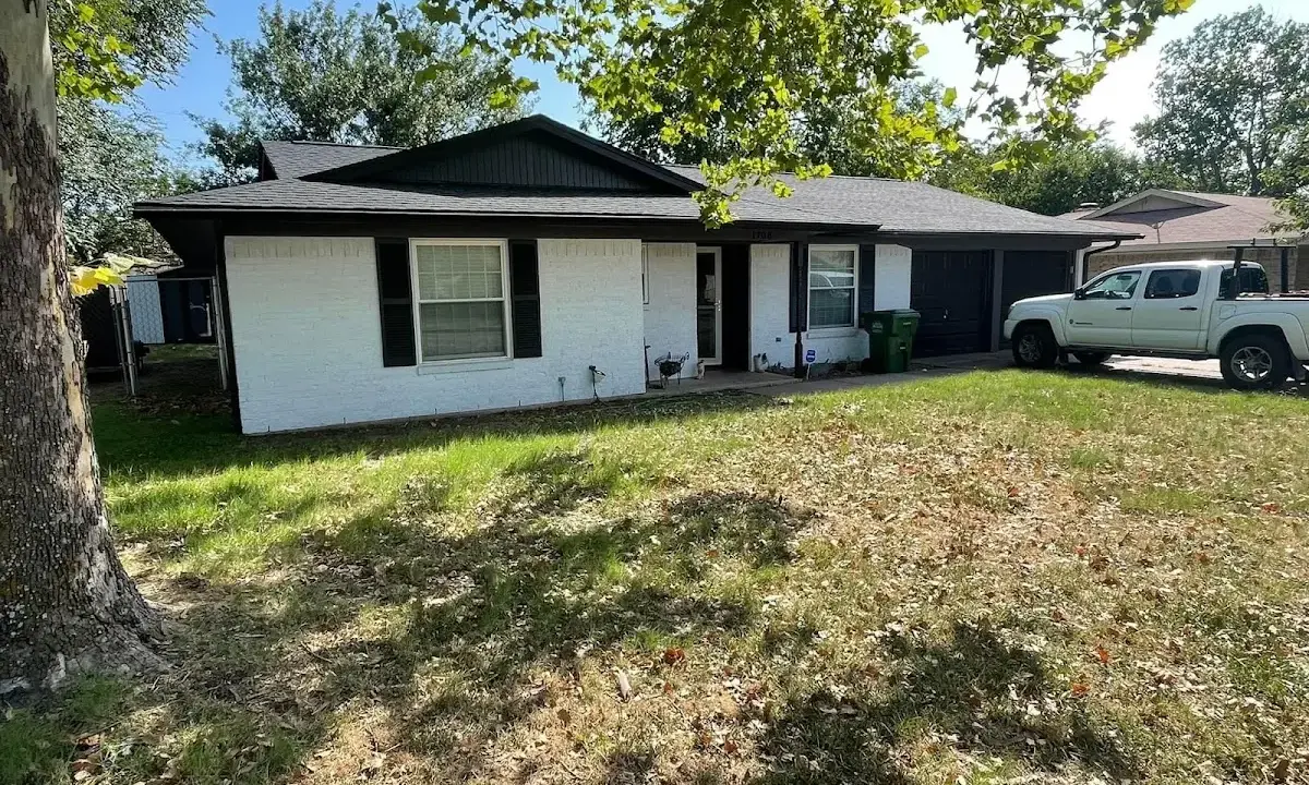 Professional roofing crew working on a residential roof in Darby